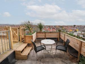 terraza con sillas y mesa en el balcón en Ty Canol, en Rhyl