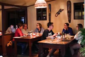 a group of people sitting at tables in a restaurant at Essence Arenal and Spa in El Castillo de La Fortuna