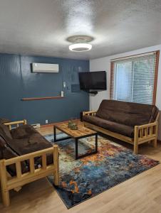 a living room with a couch and a coffee table at Anvil Campground in Williamsburg