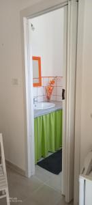 a bathroom with a tub with a green table at Villa Scavuzzo in Realmonte