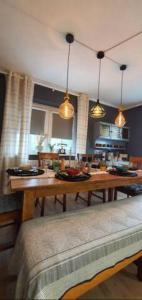 a dining room with a wooden table and lights at Schöne Wohnungen in Schwandorf in Schwandorf in Bayern