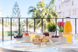 a table with a tray of breakfast food on a table at Casa Playa Bonita Primera linea de playa in Roquetas de Mar