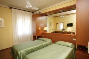 מיטה או מיטות בחדר ב-Hotel Ezzelino