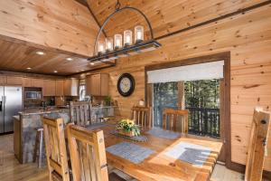 a kitchen and dining room with a large wooden table at 1 Kingfisher in Blowing Rock