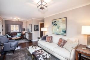 a living room with a white couch and a table at 1eight3 Retreat in Blowing Rock