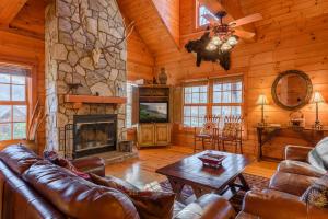 a living room with a couch and a fireplace at 3 Bears Den in Boone