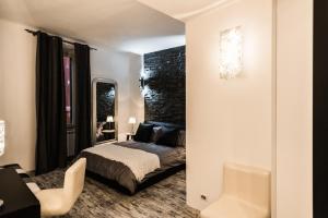 a bedroom with a bed and a desk and a chair at Trevi & Pantheon Luxury Rooms in Rome