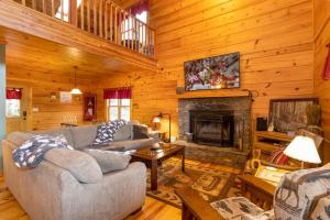 a living room with a couch and a fireplace at A Rustic Hideaway in Todd