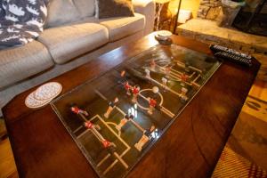 a coffee table with a game on it in a living room at A Rustic Hideaway in Todd
