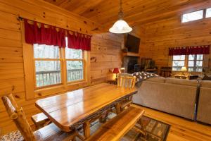 a living room with a wooden table and a couch at A Rustic Hideaway in Todd