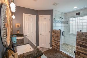 a bathroom with a tub and a sink and a shower at Ace of Diamonds in Seven Devils +41 photos