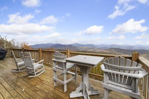 a table and chairs on a deck with a view at Almost Heaven in Boone