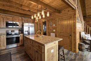 a kitchen with wooden cabinets and a large island at Almost Heaven in Boone +33 photos