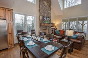 a kitchen and living room with a table and chairs at Alpine Gorge View in Blowing Rock