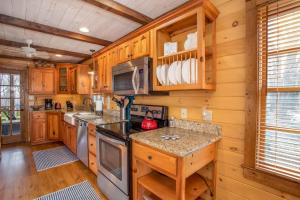 a kitchen with wooden cabinets and a stove top oven at Appalachian Escape in Blowing Rock +23 photos