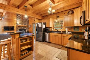 a large kitchen with wooden cabinets and stainless steel appliances at Almost There in Blowing Rock