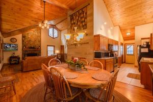 a kitchen and living room with a wooden table and chairs at Appalachian Breeze in Blowing Rock