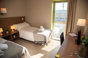 Łóżko lub łóżka w pokoju w obiekcie Hotel La Parada