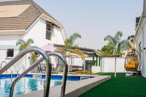 a backyard with a slide and a swimming pool at Maple studio+Gym+Snooker board Rhodabode Apt, Nile in Abuja