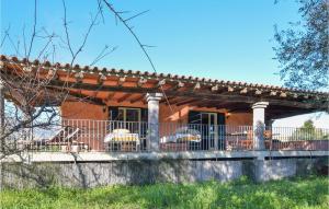 a house with a balcony with chairs on it at Lovely Home In Orosei With Kitchen in Orosei