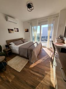a bedroom with a bed and a large window at Studio apartman Pegi in Šimuni