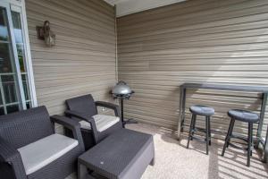 a porch with chairs and a table and stools at Bear Necessities in Beech Mountain