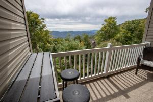 a bench on a porch with a view of the mountains at Bear Necessities in Beech Mountain +19 photos