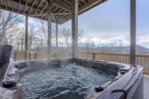 a hot tub on the deck of a house at Bear The View in Seven Devils
