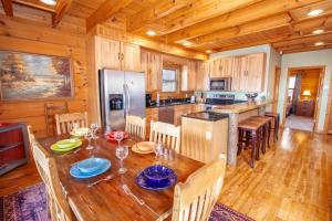 a kitchen and dining room with a table and chairs at Beech View Retreat in Zionville