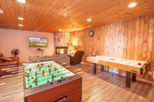 a living room with a pool table and a couch at Beech View Retreat in Zionville