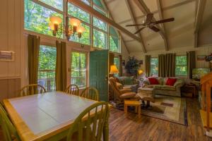 a dining room with a table and some chairs at Benzine Farm in Beech Mountain