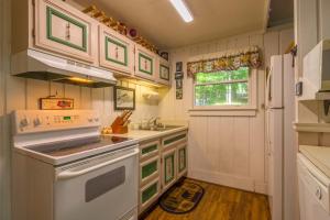 a kitchen with a stove and a sink and a refrigerator at Benzine Farm in Beech Mountain +16 photos