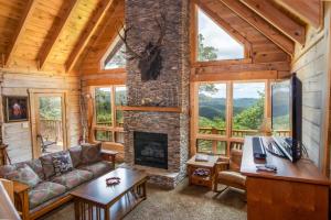 a living room with a fireplace in a log cabin at Blue Ridge View in Blowing Rock