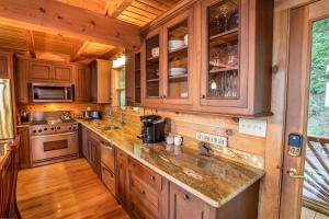 a kitchen with wooden cabinets and a counter top at Blue Ridge View in Blowing Rock +27 photos