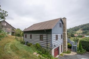 a blue house with a gray roof at Boots Off Bungalow in Boone