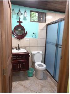 a bathroom with a toilet and a sink at Hospedaje Rosa Del Mar in Big Corn Island