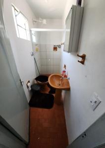 a small bathroom with a sink and a toilet at Apartamento PRATICO in Cascavel +27 photos