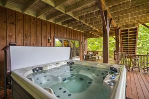 a jacuzzi tub in a house with a deck at Chimney Island in Blowing Rock