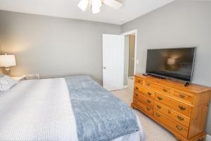 a bedroom with a bed and a television on a dresser at Condo at Pinnacle Inn Resort in Beech Mountain