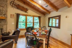 a dining room with a table and chairs at Creek Sound Chalet in Blowing Rock