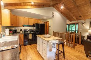 a kitchen with wooden cabinets and a counter top at Creek Sound Chalet in Blowing Rock