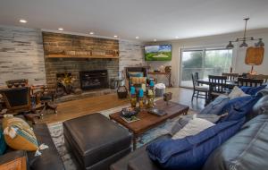 a living room with a blue couch and a fireplace at Eagles Nest on Seven Devils in Seven Devils