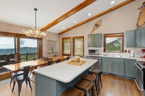 a kitchen with blue cabinets and a table and chairs at Elevated Escape in Blowing Rock