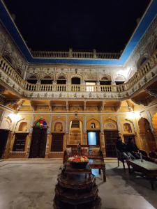 a room with a building with a table in it at Hotel Radhika Haveli, Mandawa in Mandāwa
