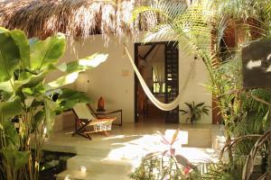 a room with a mirror and a chair and plants at Piedra de Agua Palenque in Palenque