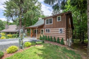 a house in the woods with a driveway at Fox Haven in Seven Devils