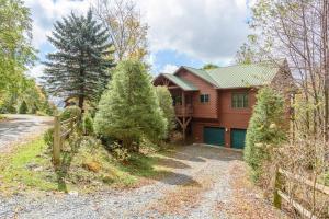 a wooden house with a fence and a driveway at Fox Crossing in Banner Elk