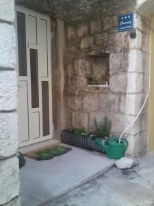 an entrance to a building with a door and potted plants at Apartments Eldi in Split