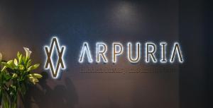 a neon sign that says arunta on a wall at Arpuria l hidden luxury mountain home - ADULTS FRIENDLY in Sankt Anton am Arlberg