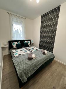 a bedroom with a bed with two towels on it at Wellness apartman in Siófok +38 photos